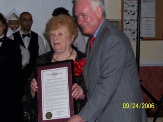 1. Honoring New Utrecht Reformed Church member Rose Giannini Lood on her 90th birthday, State senator Martin J. Golden presents her with a proclamation during a party at Bay Ridge Manor.